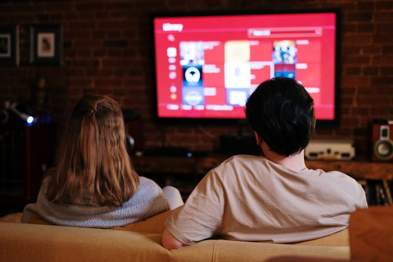 Couple watching an IPTV subscription service on a television